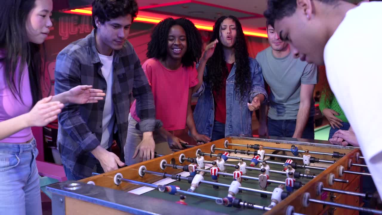Group of Friends Playing Foosball and Celebrating
