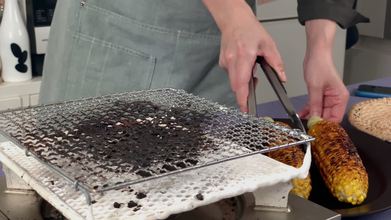 a Japanese female chef removes corn from the heat at her home kitchen, Tokyo, Japan