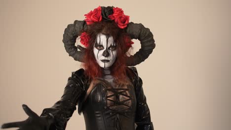 woman in a devil costume with horns and roses