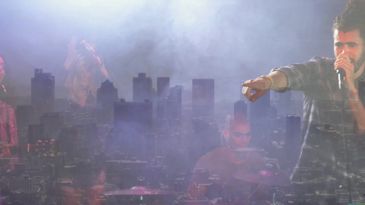 Lead singer moving inward bringing mic singing for focus as city skyline ghosting over music stage