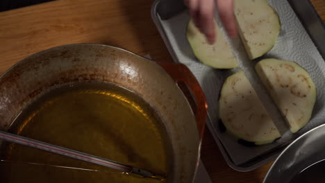 japanese female chef deep frying kamonasu at her home kitchen, tokyo, japan