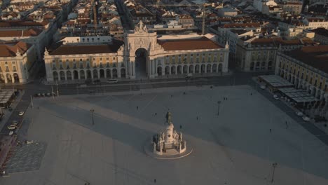 areal drone footage of the historical center praca do comercio town square in lisbon, portugal, filmed during sunset