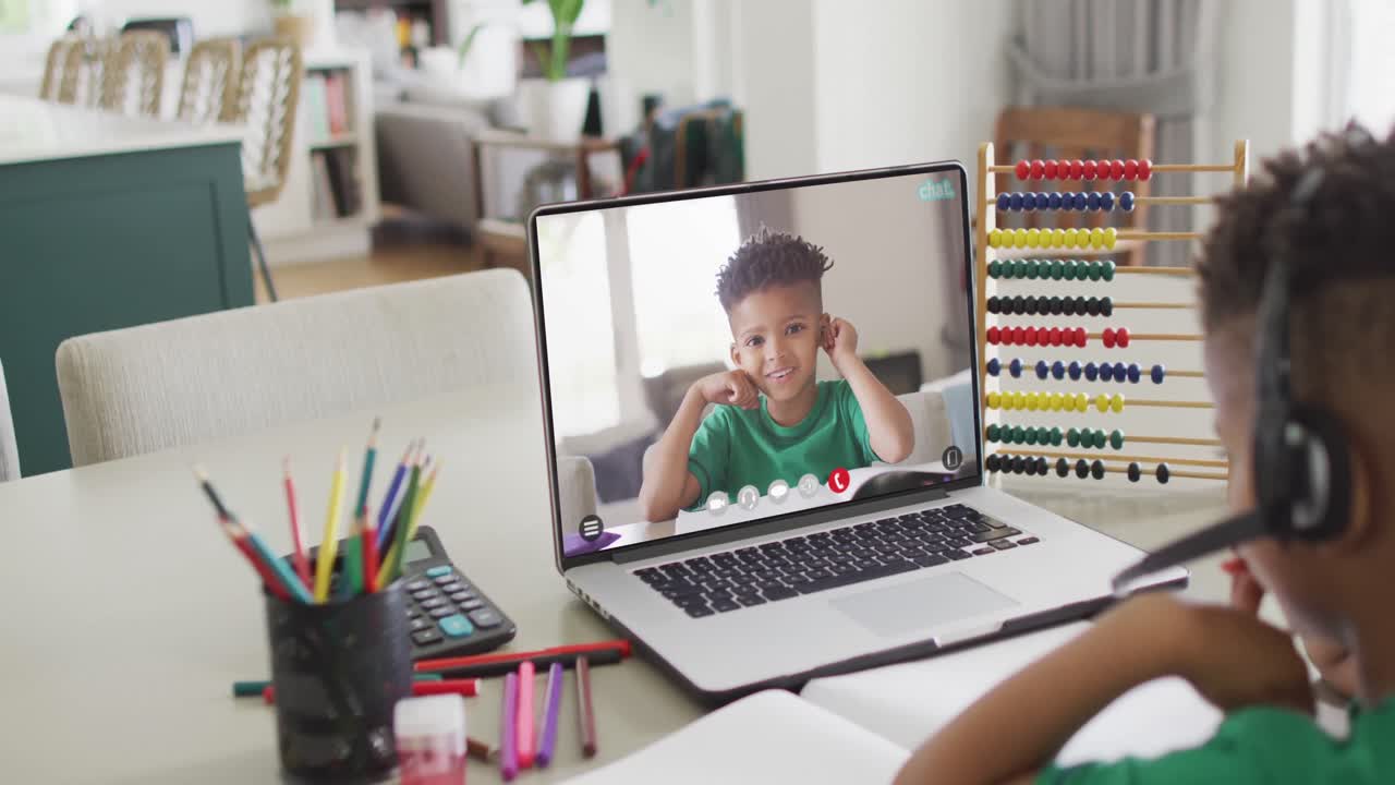 Composition of biracial boy on laptop online learning with african american schoolboy