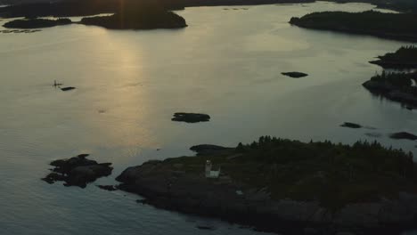 Fly-back-pan-up-revealing-lighthouse-and-sunset