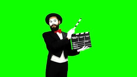 mime holding clapperboard on green screen