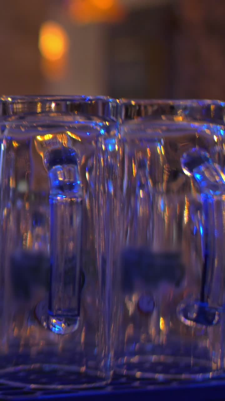 Primo piano di tazze in vetro con illuminazione blu e gialla