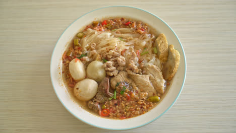 noodles with pork and meatballs in spicy soup or tom yum noodles in asian style