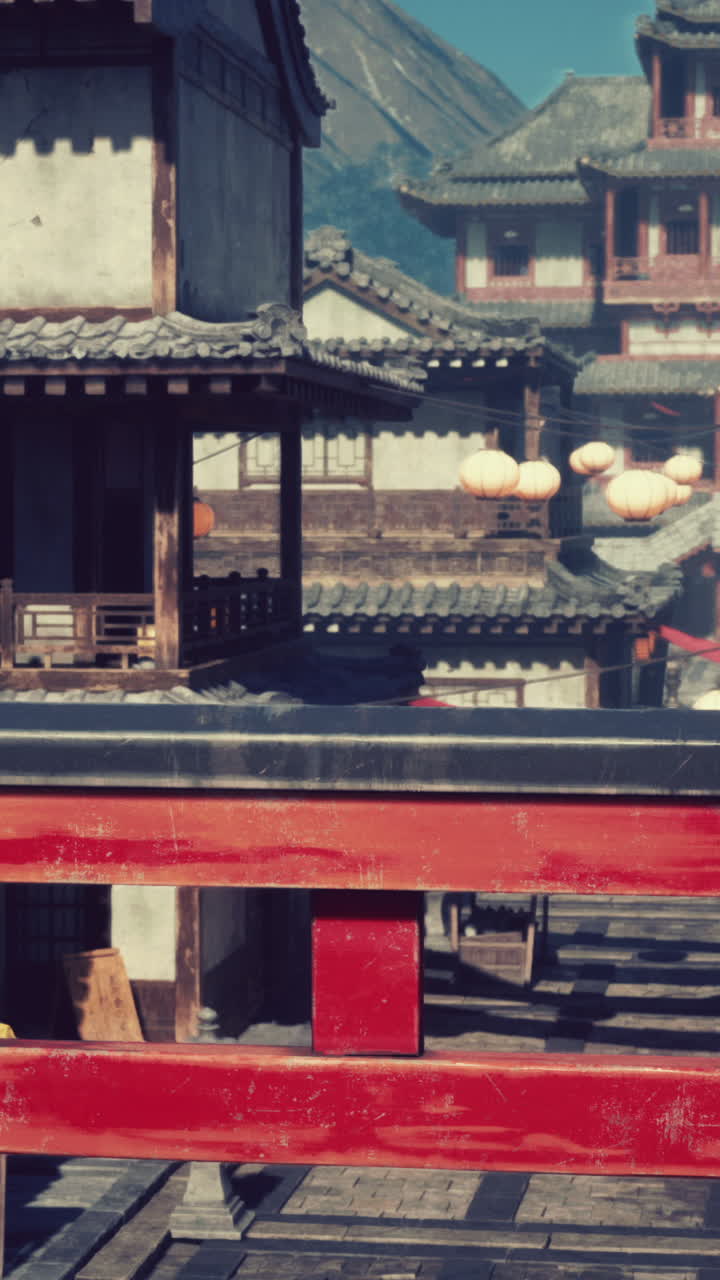 un pueblo japonés tradicional con puente rojo y linternas