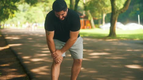 young man with knee injury pain at the park