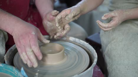 potter teaching pottery little girl