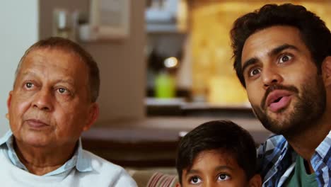 multi generation family watching tv