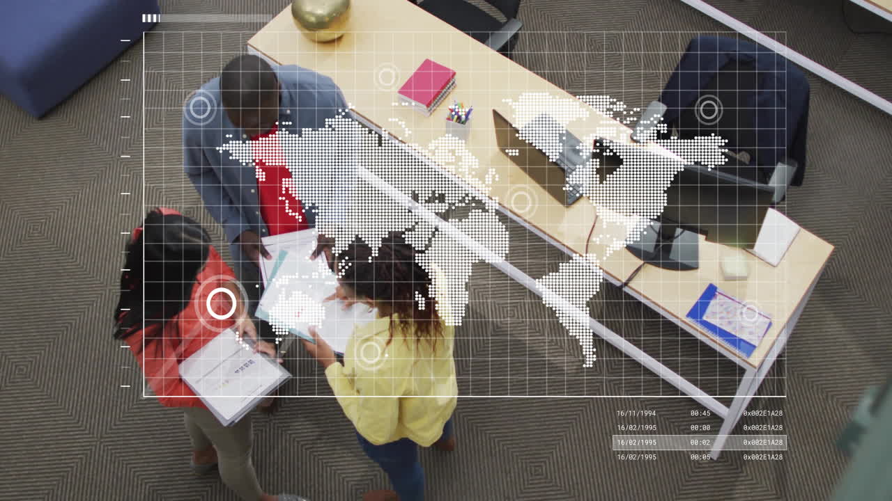 World map animation over diverse team collaborating in modern office setting