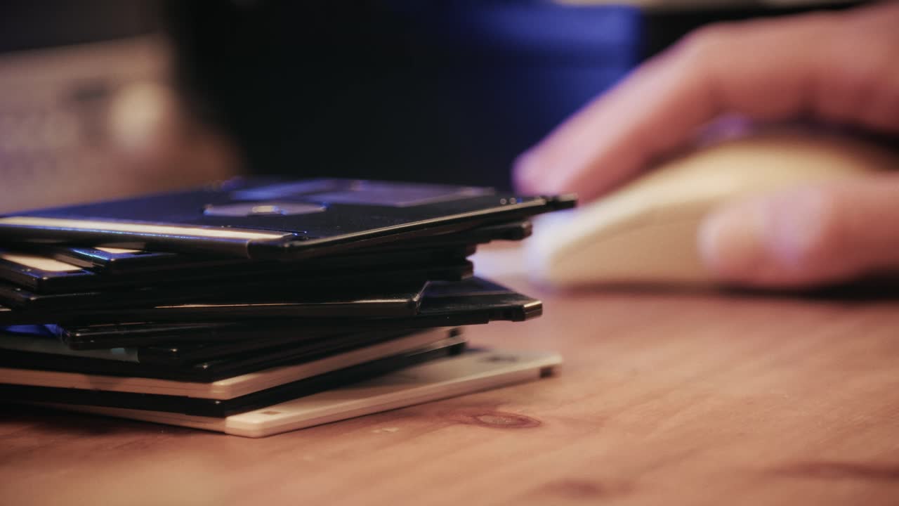 Using diskette for old computer. Music recorder, playing retro computer games. Vintage device for office, obsolete technology. . High quality 4k footage