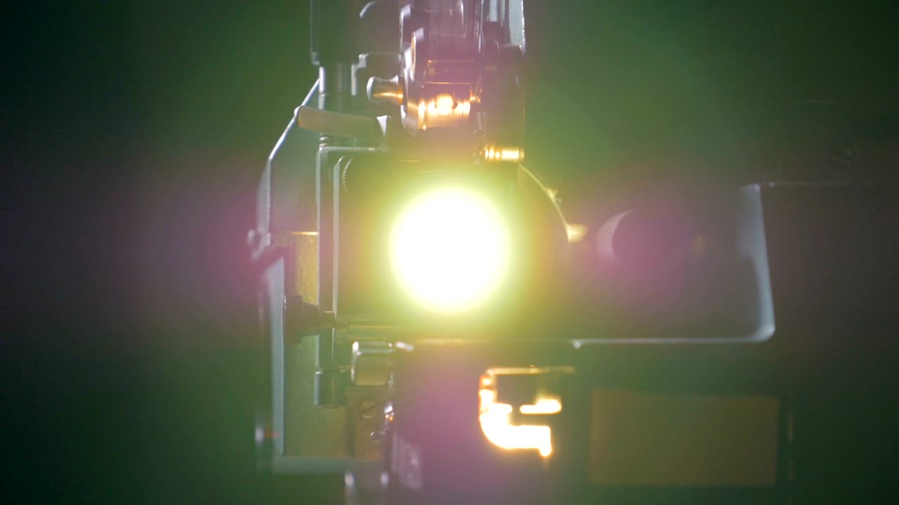 Old-fashioned movie projector in operation.