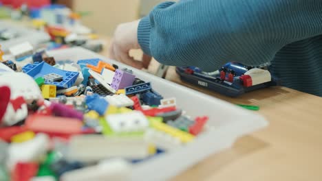 children building with plastic construction blocks