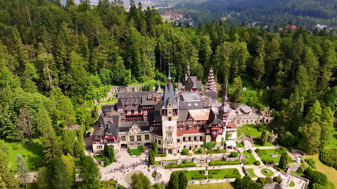 The Peles Castle in Sinaia, the Carpathians, Romania. Beautiful building surrounded by lush greenery of pine tree wood