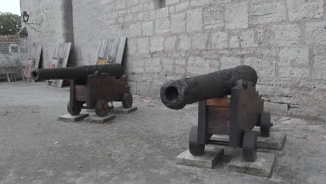 two historical cannons on display at an old fortress