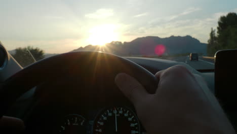 driver view of sunset over highway