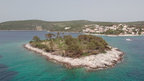 aerial shooting the coastline of the island with emerald water