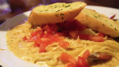 Close-up-of-seafood-pasta-and-garlic-bread