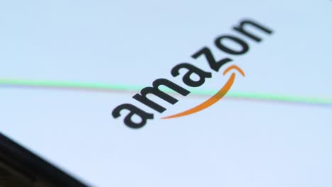 macro toque con el dedo el icono de compras de amazon en el teléfono inteligente