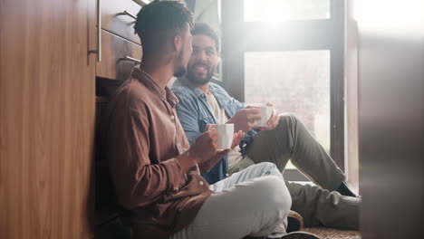 two men enjoying coffee in kitchen