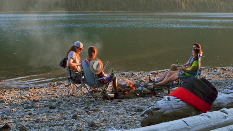 group of hikers camping near riverside 4k