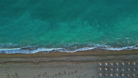 Aerial-top-down-view-of-turquoise-blue-water-in-Kiato-beach