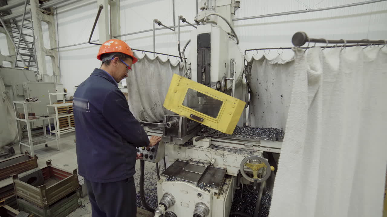 Worker Operating a Milling Machine in a Factory