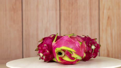 dragon fruits rotating on a white plate