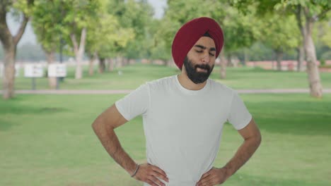 Sick-Sikh-Indian-man-suffering-from-stomach-pain-in-park