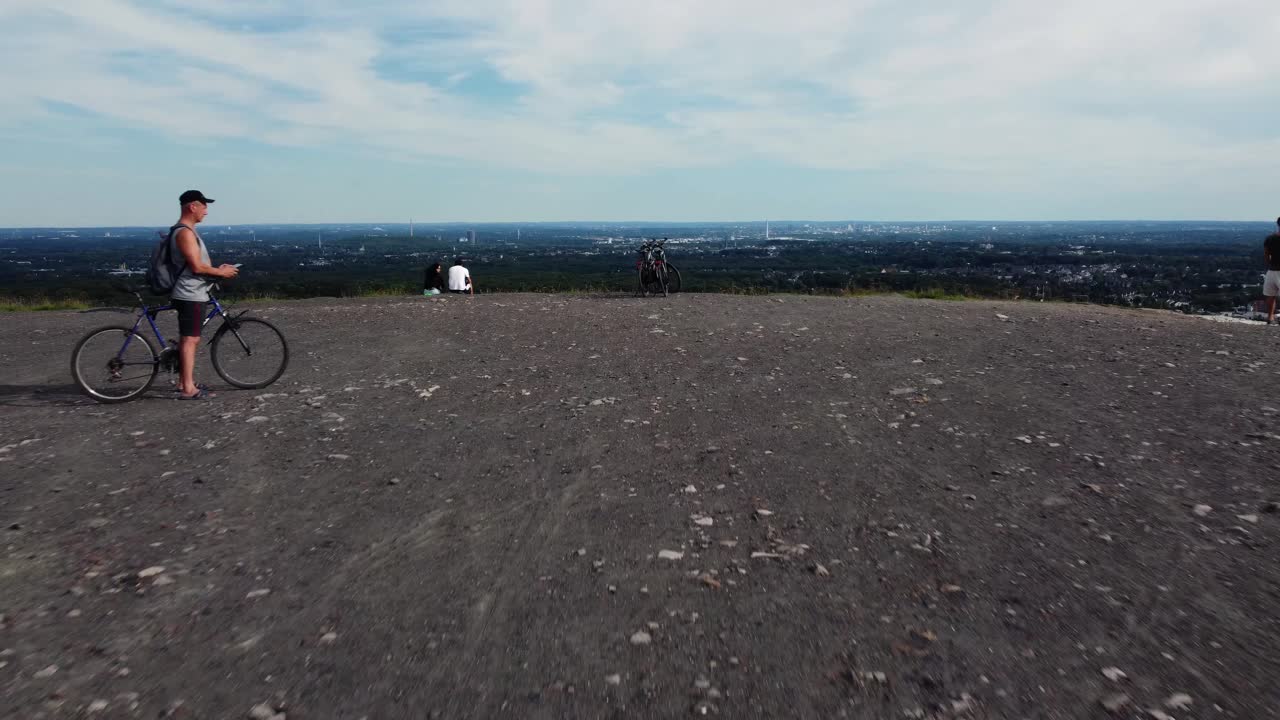 People on a hill with a bicycle