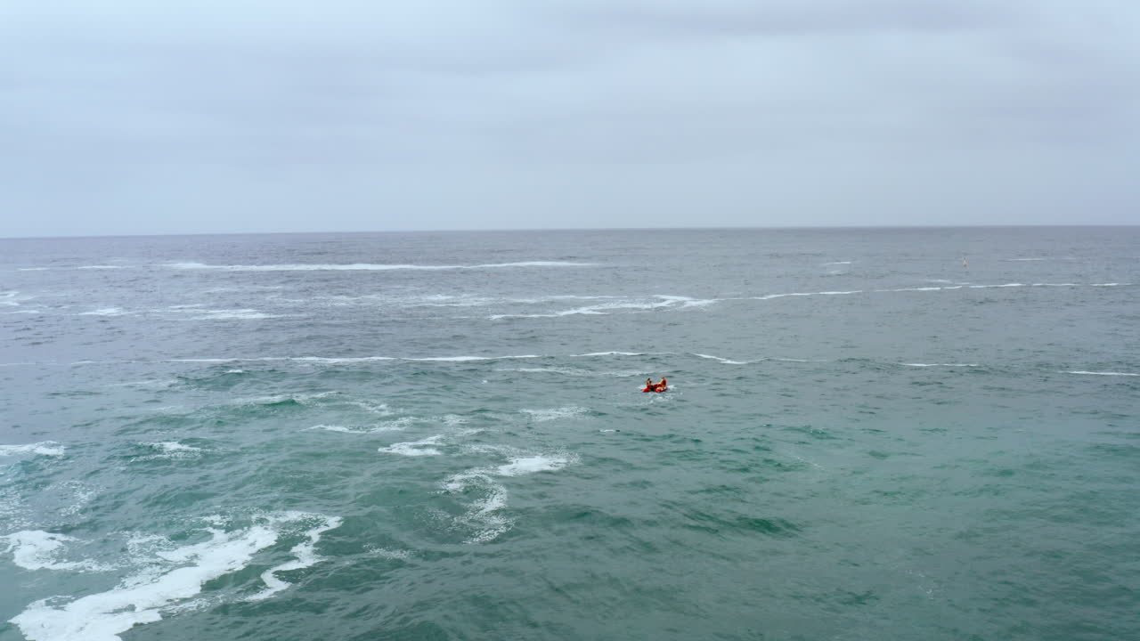 A surf life saving boat heads out into the big swell at Bondi, Sydney Australia