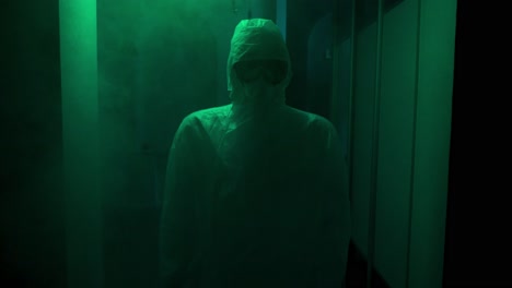 person in hazmat suit in a dark corridor