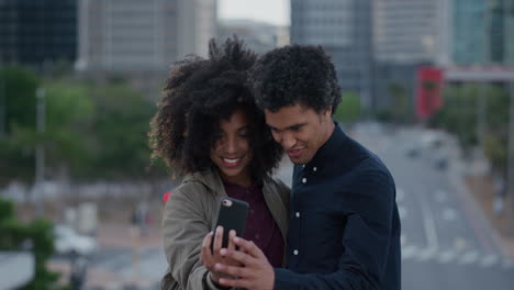portrait young african american couple using smartphone taking photos making faces enjoying relaxed urban lifestyle together in city happy relationship technology connection