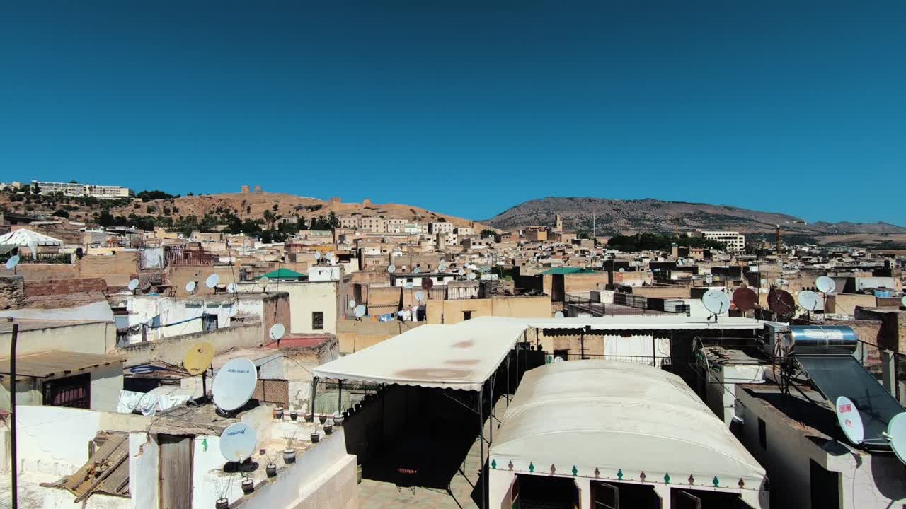 View of the old medina in Fes over the rooftops and the ruins of Fes.