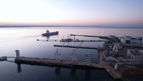 industrial boat leaving port of williamstown on blue hour, violet sunrise sky