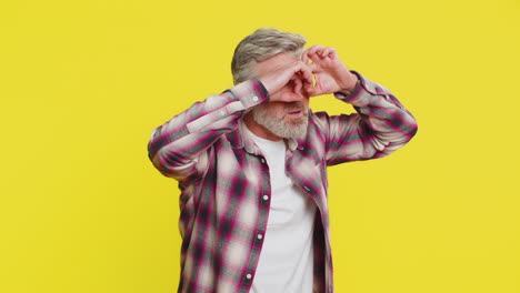 mature man creating imaginary binoculars scanning horizon playful exploration friend search gesture