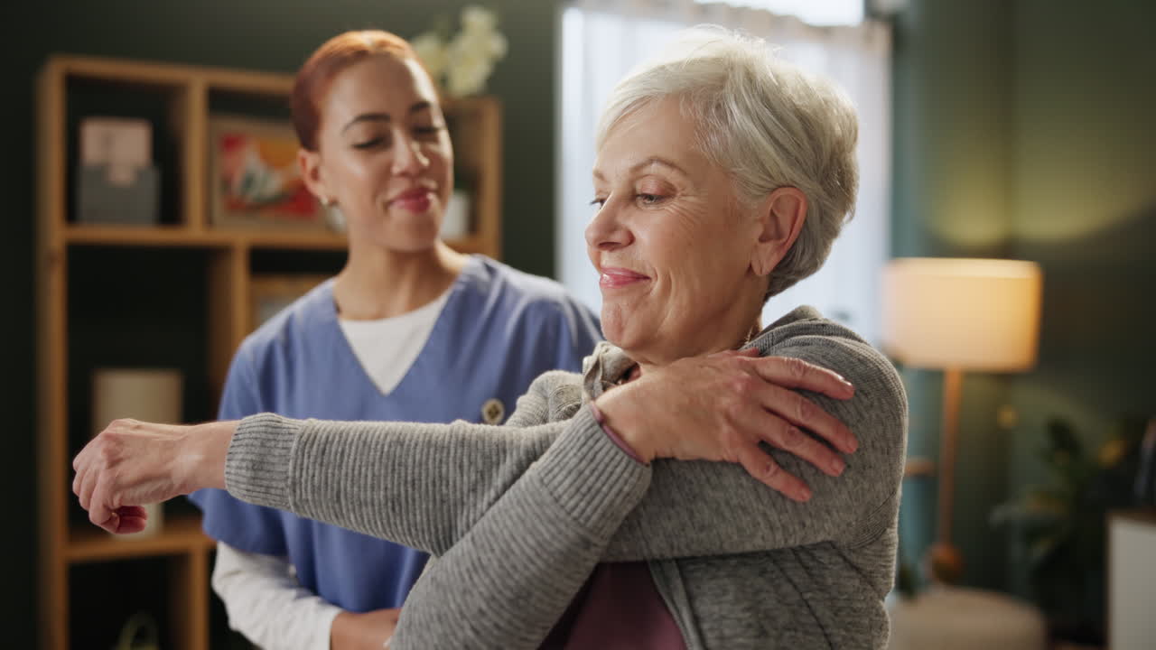 Senior Woman Doing Stretching Exercises with Caregiver