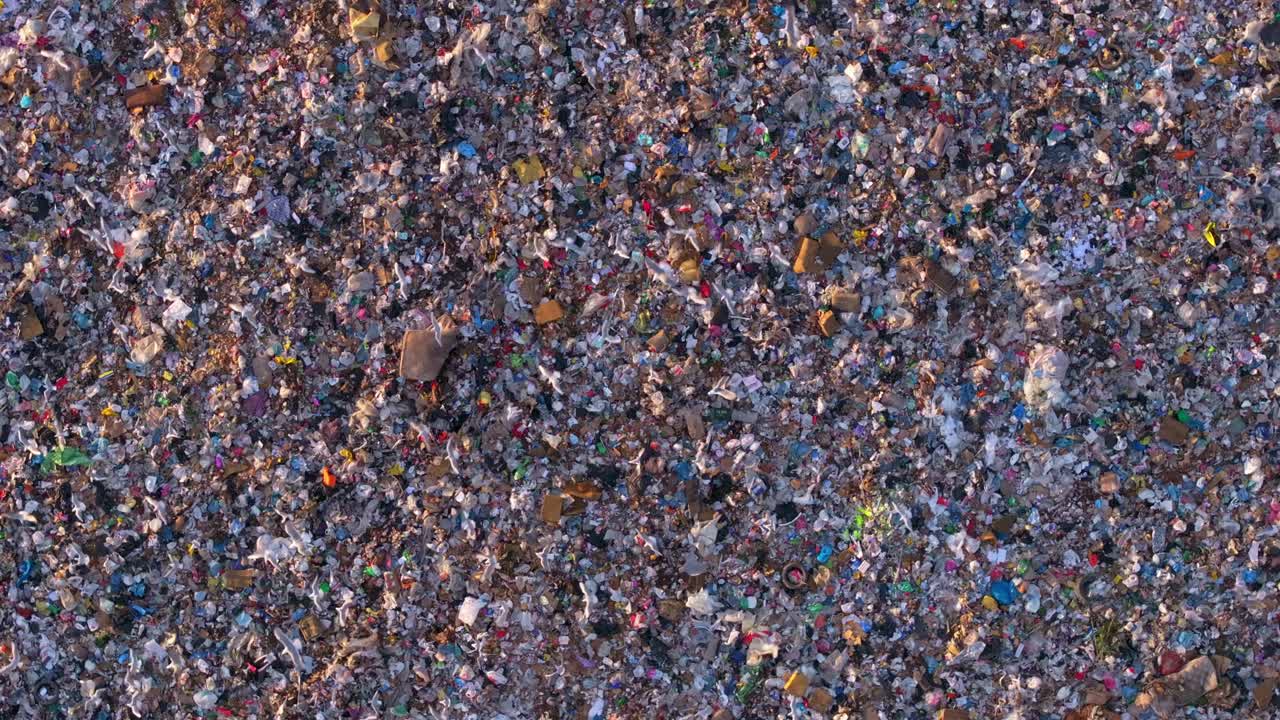 Aerial frame of a garbage dump with bulldozers moving waste, Albania