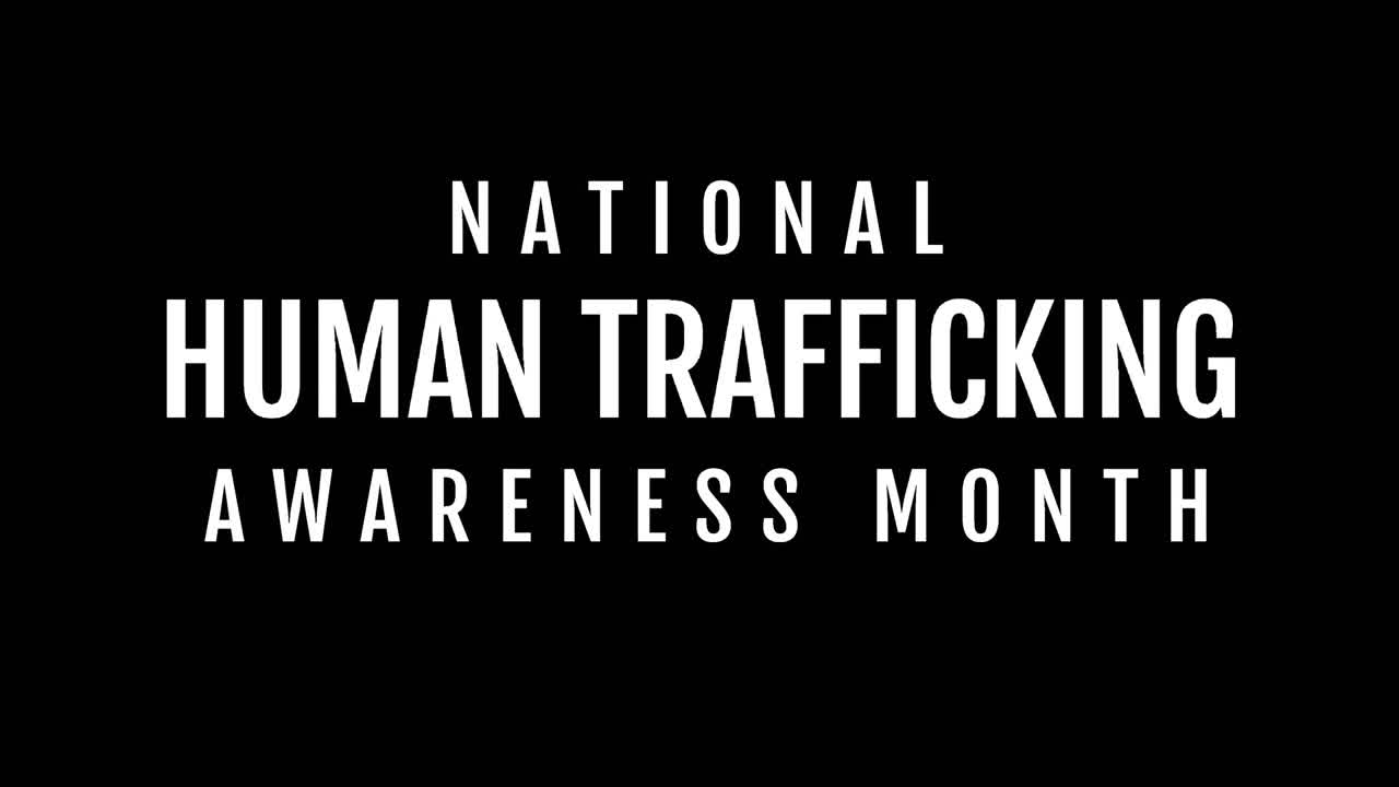 Animation of human trafficking awareness text over black background