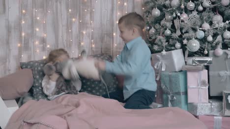 elder-brother-in-light-blue-shirt-makes-little-sister-laugh