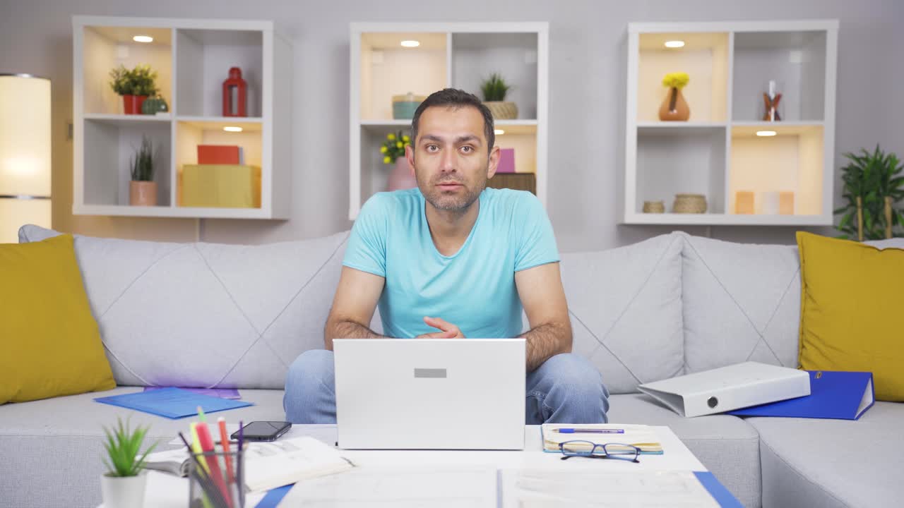 Home office worker man nods to the camera.