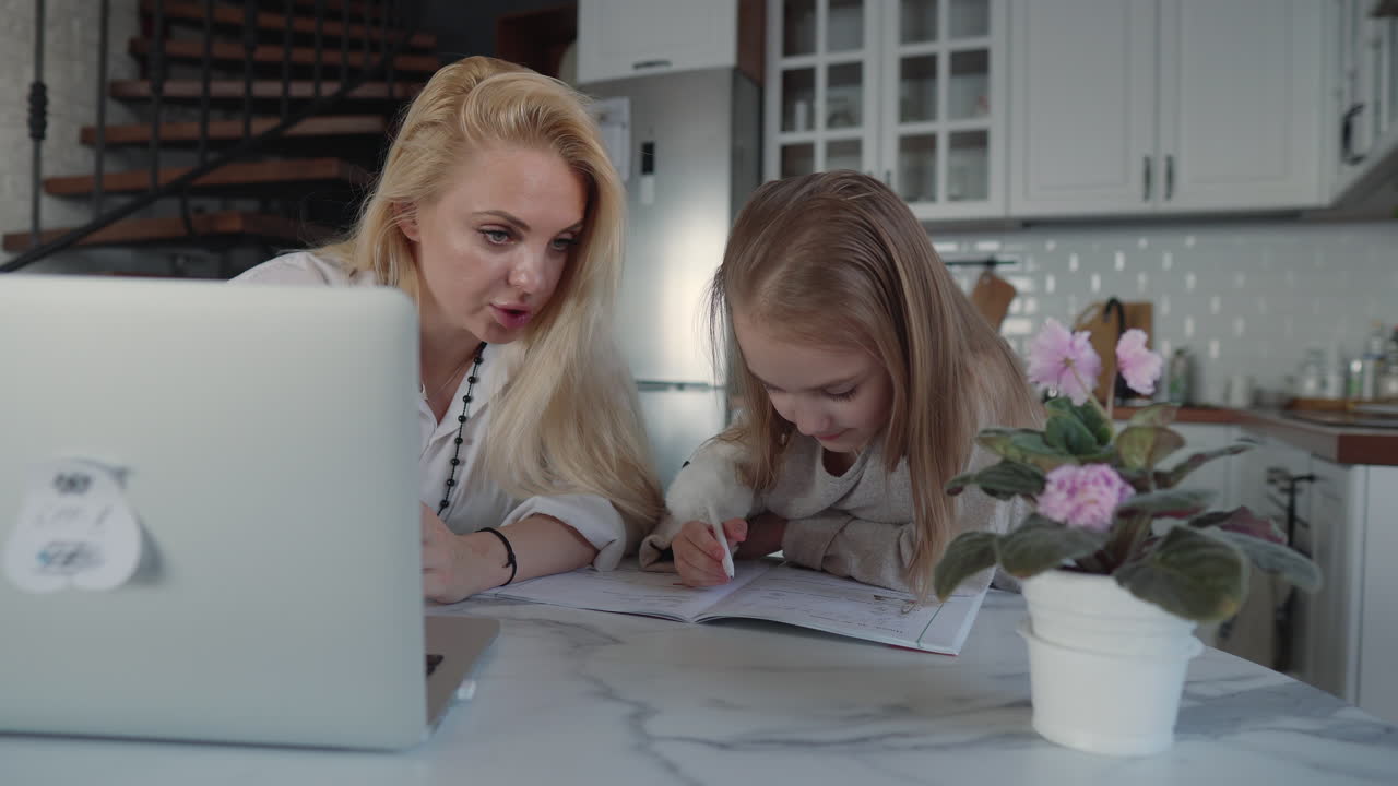 Mother Helping Daughter with Online Homework