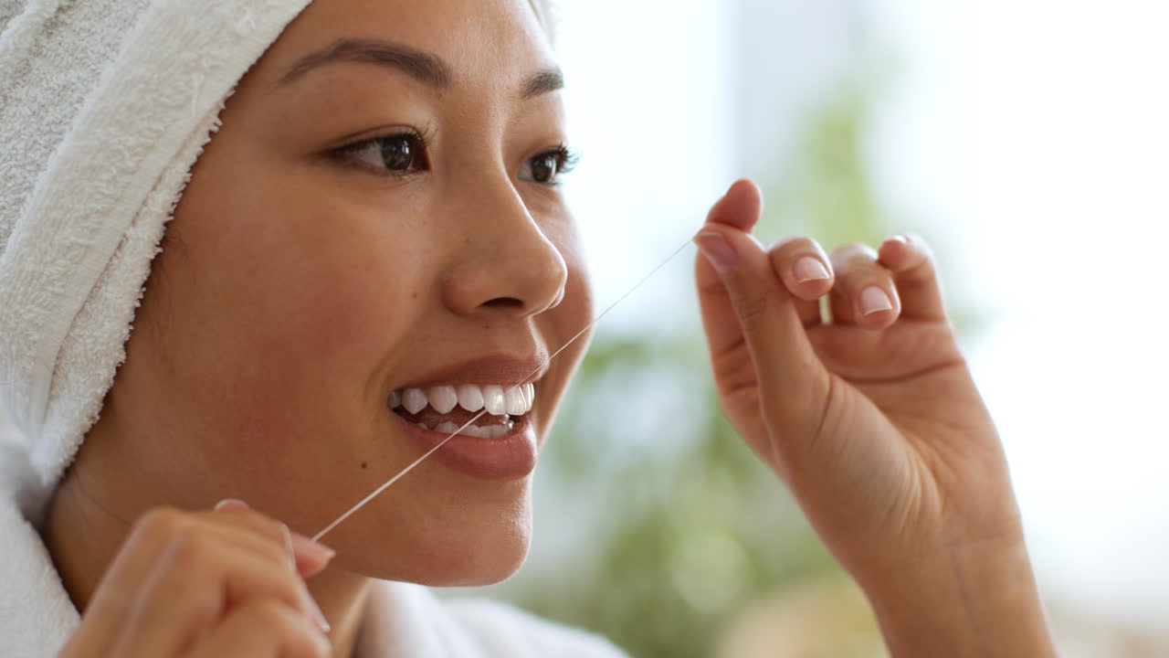 Woman Flossing Her Teeth