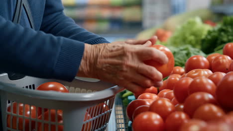 person picking fresh tomatoes in a grocery store
