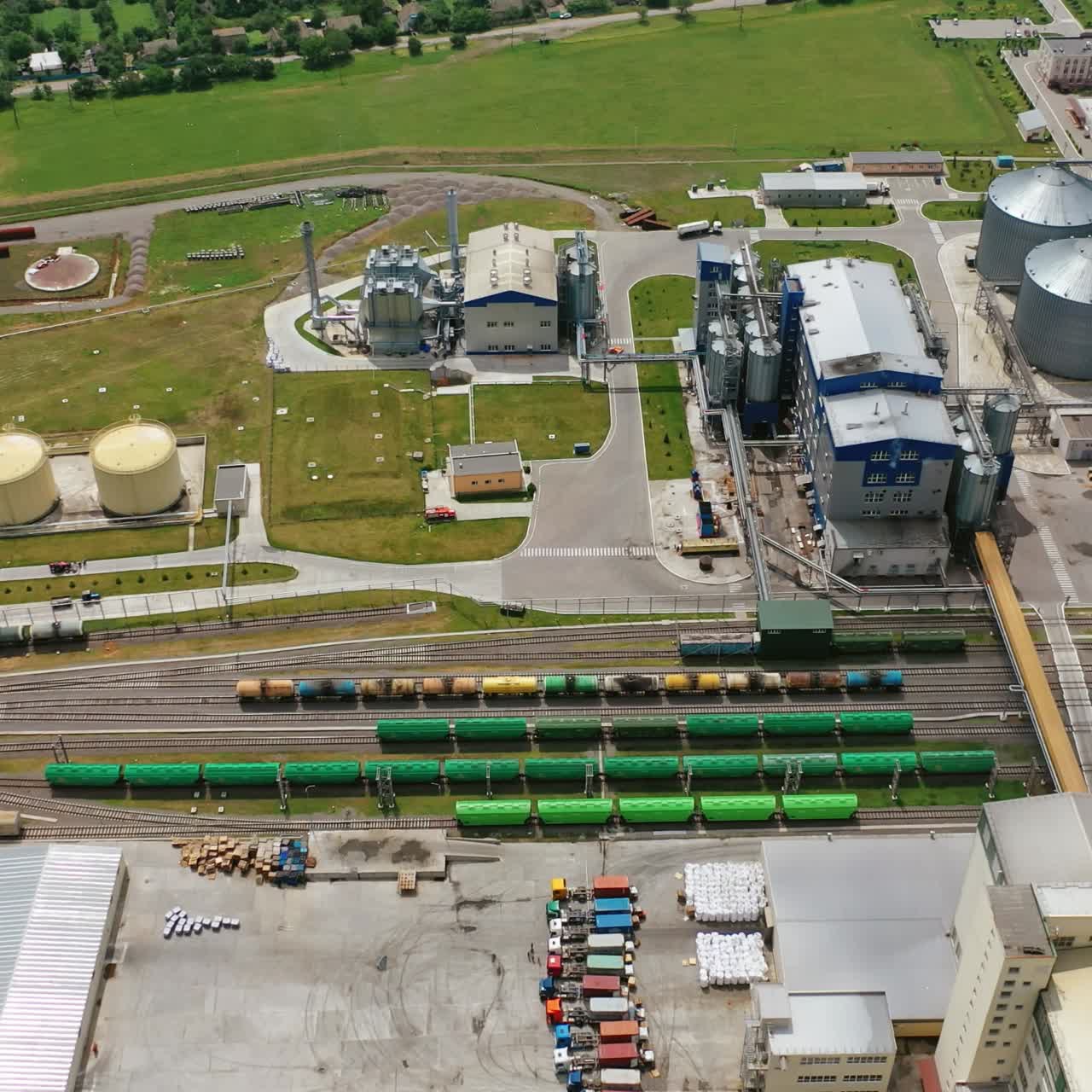 Huge industrial territory with elevators. View from above on grain storage tank in farmland. Aerial view.