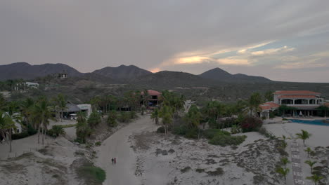 drone shot in reverse drone type at beach level in baja california sur mexico during sunset