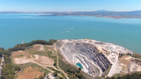 A-strip-mined-quarry-provides-raw-materials-for-a-nearby-brickyard-on-the-San-Francisco-Bay---aerial-parallax-view