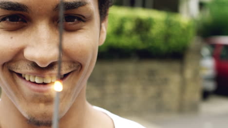 Man-holding-sparkler-celebrating-independence-day